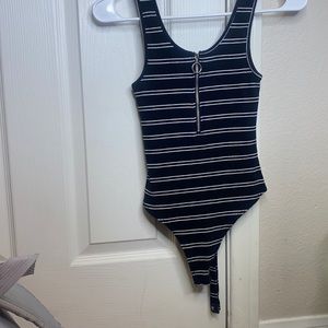 Black and white body suit size and a black dress.